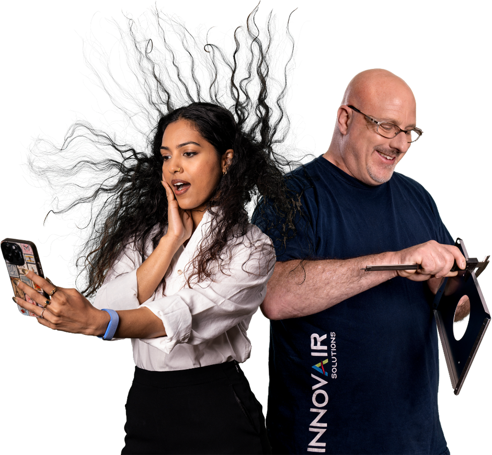 An employee caught in a gust of air next to an Innovair Solutions colleague