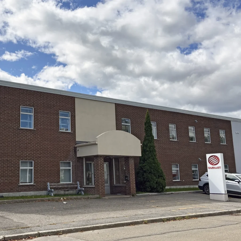 Brick façade of the Ouellet plant in Montmagny, with its sign at the entrance