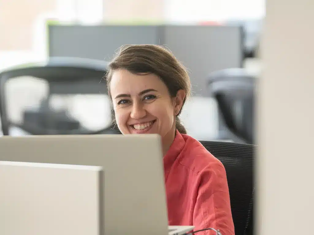 Smiling employee at a workstation in Innovair's offices